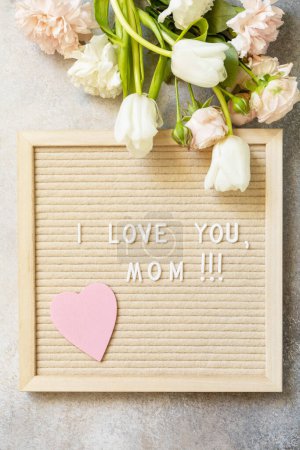 Photo for Happy Mother's Day. Letter I LOVE MOM with heart on letterboard and beautiful spring flowers. Womans day, wedding, mothers day greeting card. View from above. - Royalty Free Image