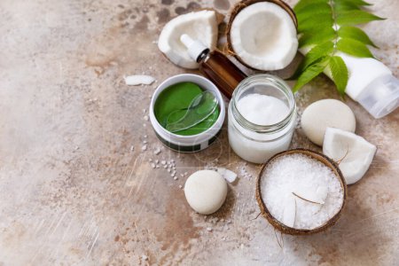 Photo for Natural organic cosmetics with coconut butter for body care, spa treatment. Fermented beauty care - coconut oil, bath salt, cosmetic cream, serum and hydrogel eye patches. Copy space. - Royalty Free Image