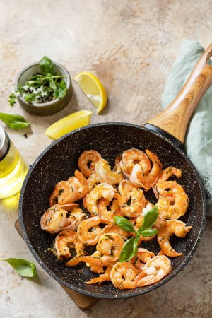 Photo for Spicy garlic chili Shrimps boiled shrimps and herbs, prawns in a frying pan with lemon. Seafood, shellfish. Copy space - Royalty Free Image