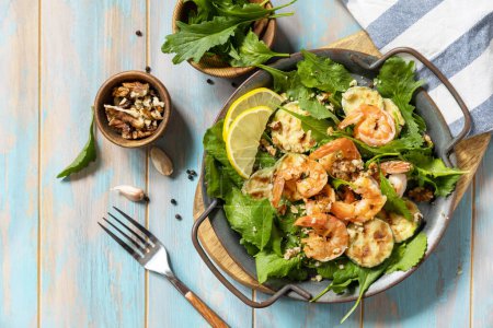 Photo for Healthy food concept. Diet summer salad plate. Shrimps salad with arugula, grilled zucchini and walnut. View from above. - Royalty Free Image