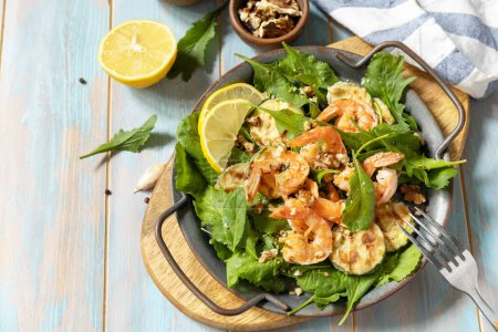 Photo for Healthy food concept. Diet summer salad plate. Shrimps salad with arugula, grilled zucchini and walnut. Copy space. - Royalty Free Image