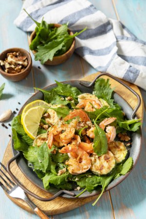 Photo for Healthy food concept. Diet summer salad plate. Shrimps salad with arugula, grilled zucchini and walnut. - Royalty Free Image