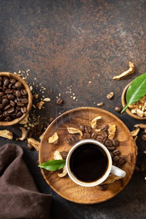 Photo for Healthy organic energizing adaptogen. Mushroom coffee in a cup and coffee beans, trendy drink on a stone background. Copy space. View from above. Copy space. - Royalty Free Image