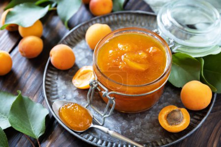 Photo for Homemade preservation. Delicious apricots jam or jelly on a rustic wooden table. - Royalty Free Image