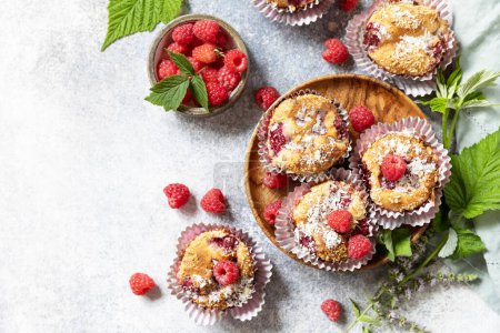 Photo for Healthy dessert. Vegan gluten-free pastry. Oatmeal banana muffins with raspberry and coconut flakes on a stone table. View from above. Copy space. - Royalty Free Image