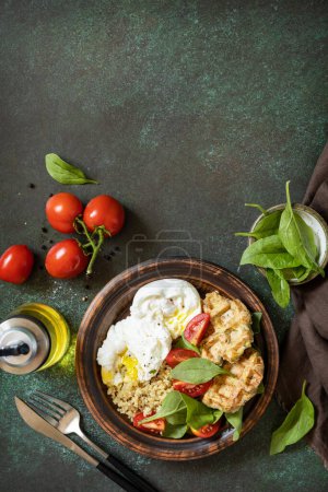 Photo for Keto diet. Delicious breakfast or brunch - zucchini vegan waffles, poached egg, quinoa and fresh vegetable salad on a stone tabletop. View from above. Copy space. - Royalty Free Image