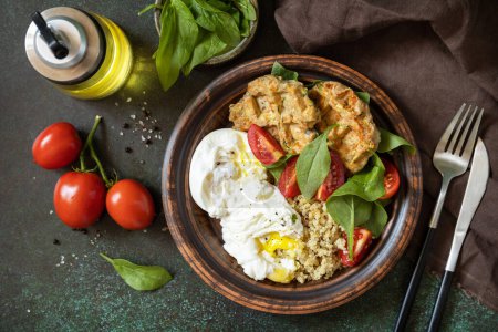 Photo for Keto diet. Delicious breakfast or brunch - zucchini vegan waffles, poached egg, quinoa and fresh vegetable salad on a stone tabletop. View from above. - Royalty Free Image