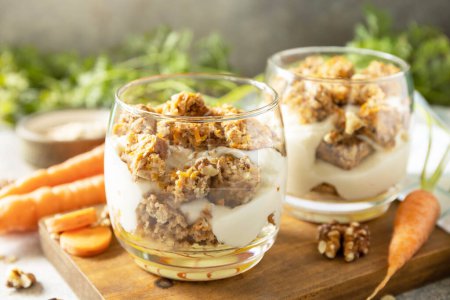 Healthy dessert. Vegan gluten-free pastry. Carrot cake with walnuts and cinnamon in a glass on a light background.