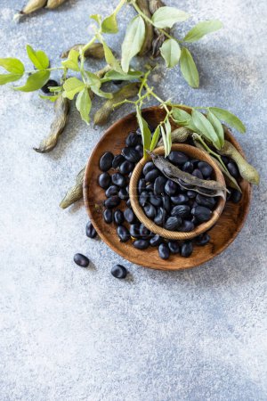Photo for Organic food.  The concept of vegan or diet food. Fresh ripe black soy beans on a stone background. View from above. Copy space. - Royalty Free Image