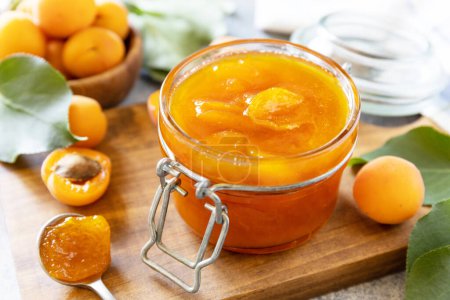 Photo for Delicious apricots jam or jelly on a stone table. Homemade preservation. - Royalty Free Image