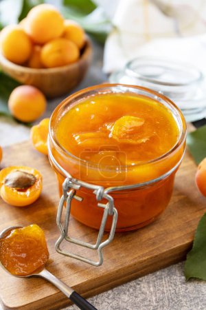 Photo for Homemade preservation. Delicious apricots jam or jelly on a stone table. - Royalty Free Image