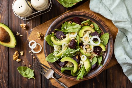 Photo for Vegan food, low calories dieting meal.Couscous with avocado, beet, green beans, spinach on a rustic wooden table. View from above. - Royalty Free Image