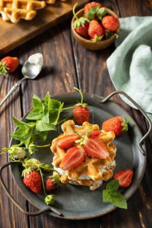 Photo for Homemade Belgian waffles with fresh berrie strawberries and ricotta cheese for breakfast on a rustic table. - Royalty Free Image
