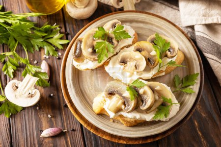 Photo for Homemade bruschetta with mushrooms. Toasted sandwich from baguettes bread with soft cheese and grilled mushrooms on wooden rustic table. - Royalty Free Image