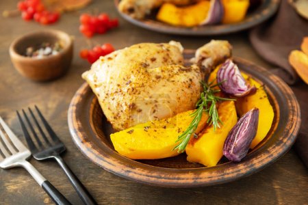 Photo for Homemade Thanksgiving dinner ripe pumpkin and Thanksgiving turkey on a dark wooden table. - Royalty Free Image