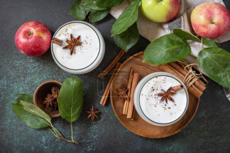 Photo for Autumn still life Background. Healthy nutrition: apple smoothie with cinnamon on a dark stone background. View from above. - Royalty Free Image