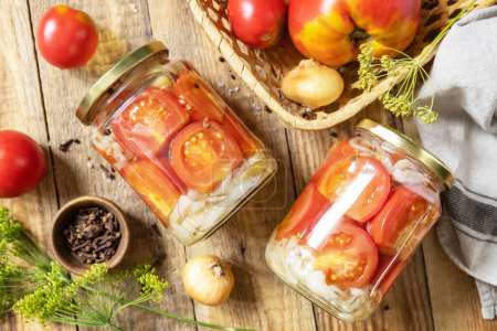 Photo for Healthy homemade fermented food. Salted pickled tomatoes and onions preserved canned in glass jar. Home economics, autumn harvest preservation. View from above. - Royalty Free Image