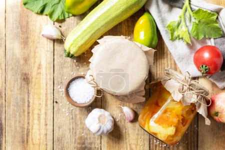Photo for Healthy homemade fermented food. Salad with courgette (zucchini) and vegetables on a rustic table. Home economics, autumn harvest preservation. View from above. Copy space. - Royalty Free Image
