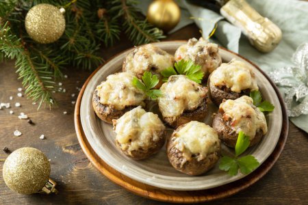 Traditional Polish Christmas dish on the table. Baked mushrooms stuffed with meat, bacon and cheese. 