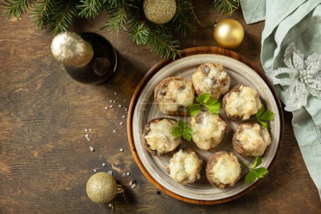 Photo for Traditional Polish Christmas dish on the table. Baked mushrooms stuffed with meat, bacon and cheese. View from above. Copy space. - Royalty Free Image