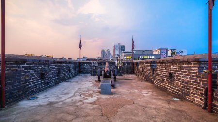Photo for Ancient cannons on the wall of Hwaseong Fortress at dusk. This historical place is the Famous Unesco World Heritage in Suwon, South Korea. - Royalty Free Image