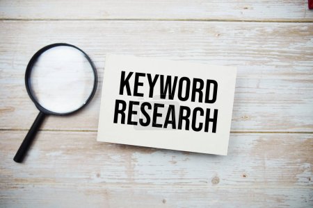 Photo for Keyword Research text message and magnifying glass with space copy on wooden background - Royalty Free Image