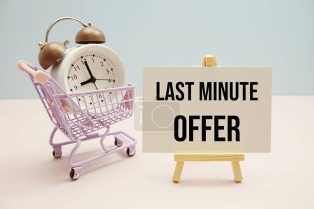 Photo for Last Minute Offer text message for promotion with alarm clock and shopping trolley cart on pink and blue background - Royalty Free Image