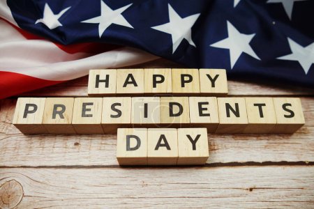 Happy Presidents Day alphabet letter and American flag on wooden background