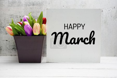 Photo for Happy March text message with flower bouquet on wooden background - Royalty Free Image