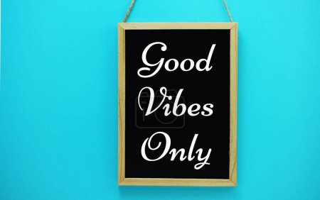 Photo for Good Vibes Only typography text on blackboard hanging against on the wall background - Royalty Free Image