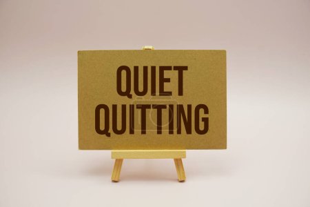 Photo for Quiet Quitting text message with wooden easel on pink background - Royalty Free Image