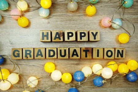 Photo for Happy Graduation alphabet letters with LED cotton balls decoration on wooden background - Royalty Free Image