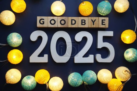 Photo for Goodbye 2025 alphabet letter with cotton ball LED decoration on blue background - Royalty Free Image