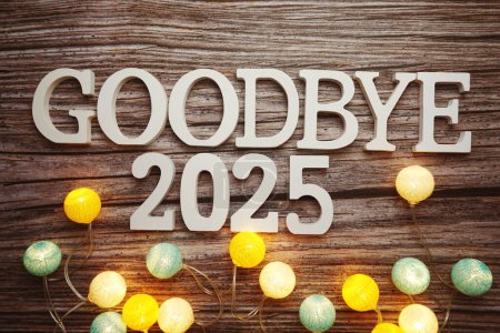 Photo for Goodbye 2025 alphabet letter with cotton ball LED decoration on wooden background - Royalty Free Image