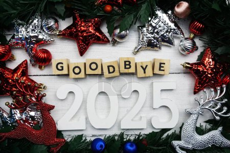 Photo for Goodbye 2025 alphabet letters and christmas decoration on wooden background - Royalty Free Image