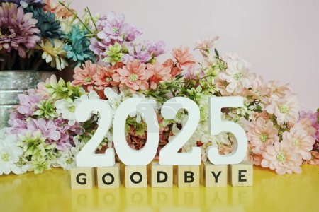 Photo for Goodbye 2025 alphabet letters and flowers blooming bouquet on yellow background - Royalty Free Image