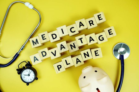 Medicare Advantage Plane with wooden blocks alphabet letters and stethoscope on yellow background