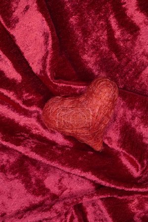 Photo for A red velvet heart shaped on a red velvet fabric. valentine 's day concept - Royalty Free Image