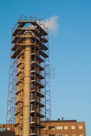 Photo for Detail of Chimney surrounded by construction scaffolding - Royalty Free Image
