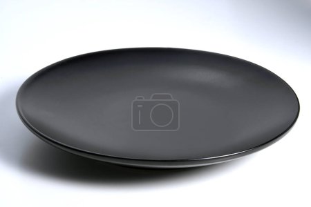 Photo for Empty Black plate with rounded edges om white background - Royalty Free Image