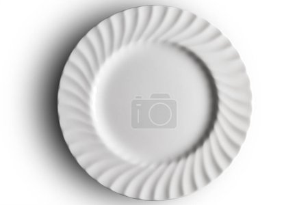 Top view of Empty white dinner plate with wavy relief edge isolated on white background