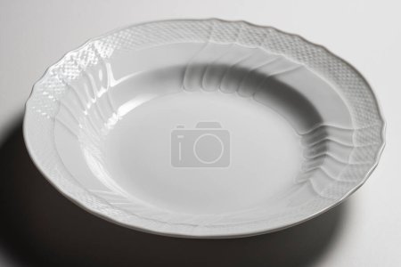 Empty white soup plate bowl with elegant classic decorations isolated on white background
