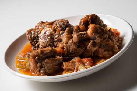 Isolated Bowl with a portion of oxtail stewed vaccinara on white background