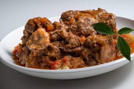 Isolated Bowl with a portion of oxtail stewed vaccinara on white background