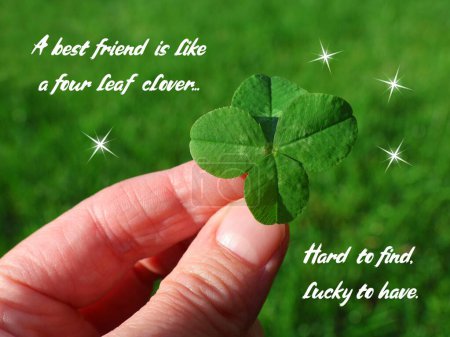 Card about friendship and happiness. Four leaf clover in a hand with text 'A best friend is like a four leaf clover. Hard to find, lucky to have. '