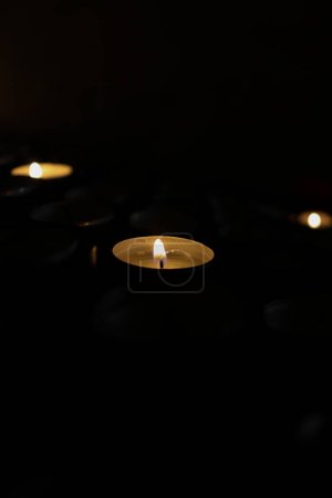 Photo for A Closed up Picture of Little Candle in the Dark as the Only Source of Bright - Royalty Free Image