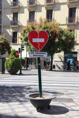 Photo for No violencia machista traffic sign seen in a shopping street in Spain against transgressive behaviour - Royalty Free Image