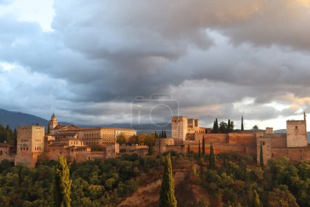 Photo for The Full View of Alhambra, Moorish Historic Castle, Located in Granada, Spain with Dramatic Sky in Sunset - Royalty Free Image