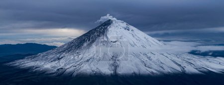Photo for Mount Chimborazo in Ecuador during a flyby, showihg smoke from the top. The volcano erupted only 2 hours after this shot.. - Royalty Free Image