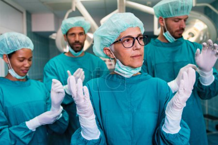Photo for Team of surgeons in the operating room preparing for surgery in hospital - Royalty Free Image